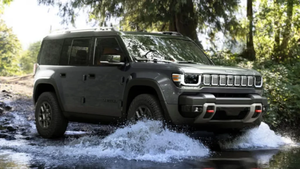 Jeep officially launches new all electric Recon SUV driving through a shallow stream in a forest
