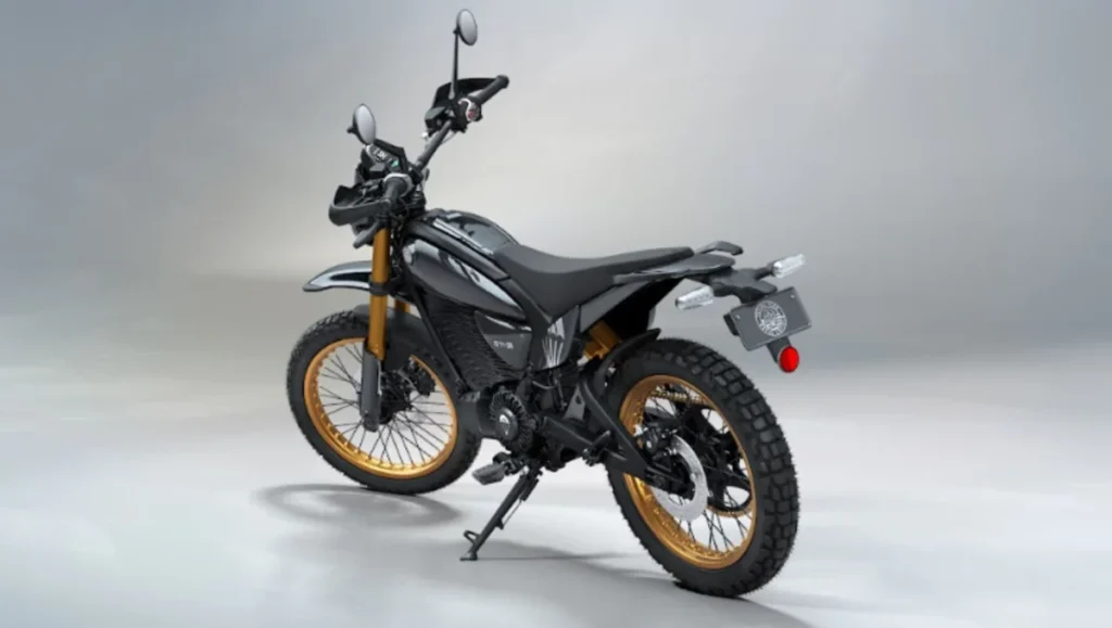 Royal Enfield Flying Flea S6 Scrambler rear three-quarter view showcasing golden spoke wheels and off-road design.