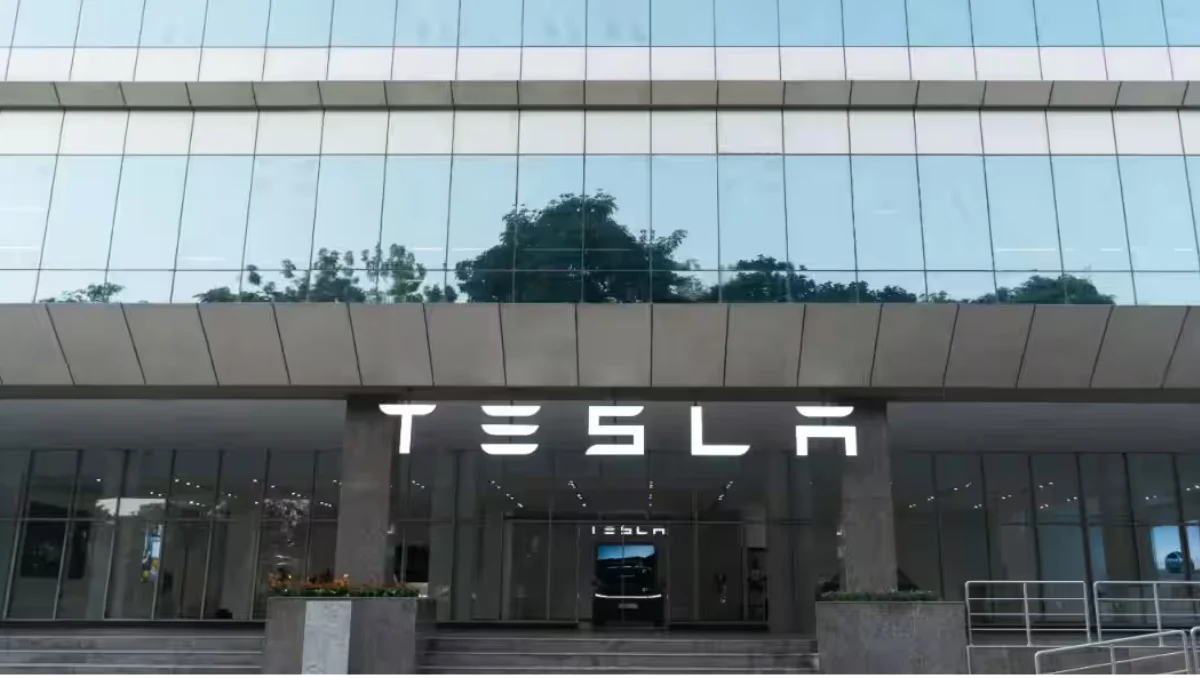 Tesla Opens First India Tesla Centre in Gurugram exterior view showing Tesla illuminated signage and glass facade at Orchid Business Park
