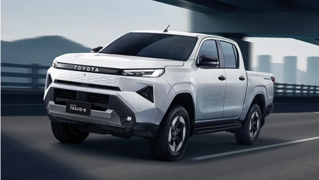 New Toyota Hilux Debuts 2026 electric version – white pickup truck driving in city environment