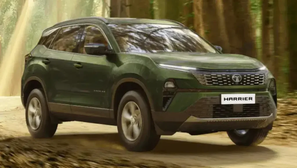 Tata Harrier facelift in green driving through forest trail with updated front design