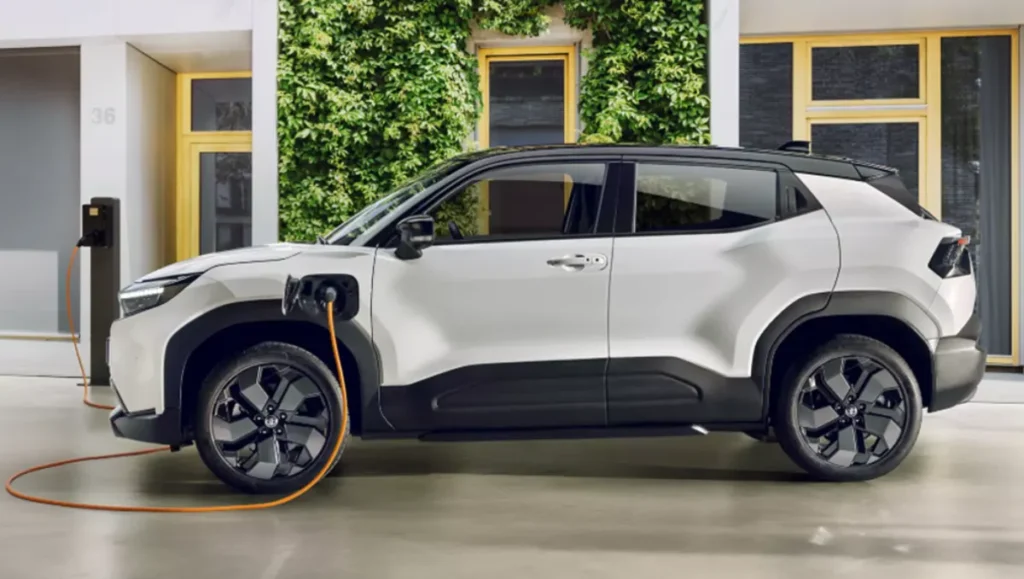 Toyota Urban Cruiser BEV Introduced In Indonesia side profile while charging showing white electric SUV plugged into charger