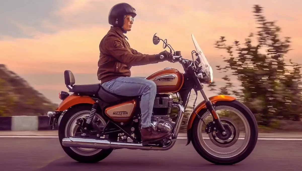 Royal Enfield Meteor 350 Sundowner Orange Launched cruising on highway with touring windscreen and backrest