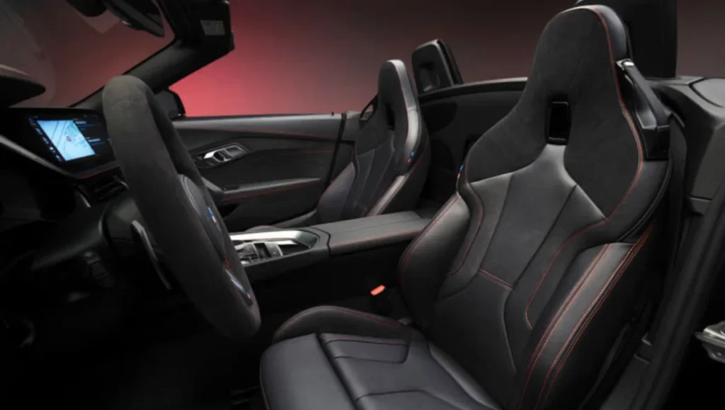 Interior of BMW Z4 Final Edition featuring Alcantara steering wheel and red stitched sport seats