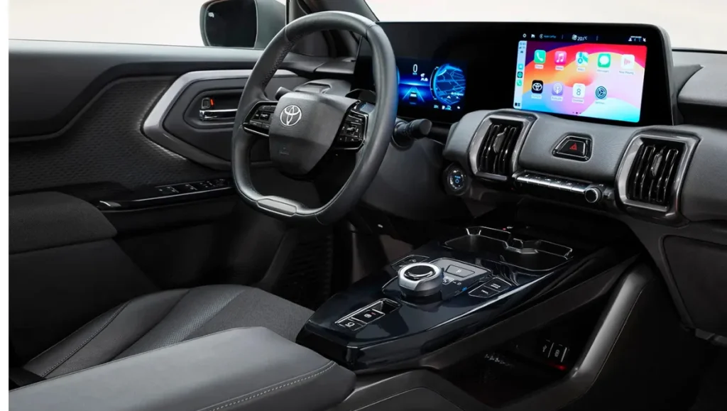 Toyota Urban Cruiser BEV interior dashboard showing digital instrument cluster, touchscreen infotainment and steering wheel layout