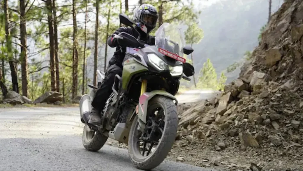TVS Apache RTX 300 Clinches IMOTY 2026 Title as the adventure motorcycle is ridden on a mountain road showcasing balance and real world capability
