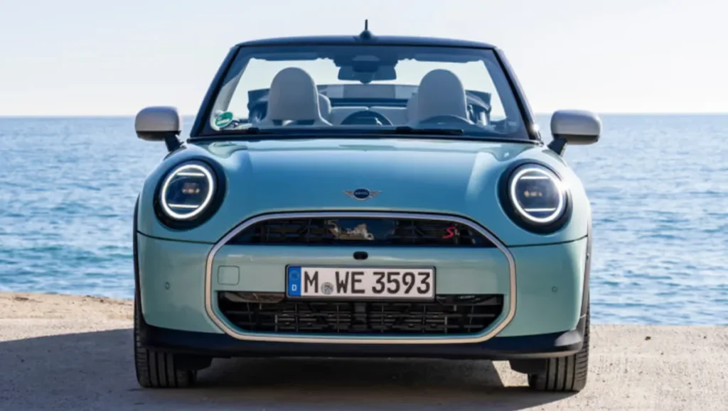 New Mini Cooper S Convertible launched front view in blue with roof down by the seaside