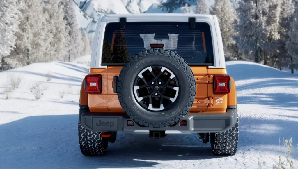 Rear view of the 2026 Jeep Wrangler Whitecap showing the Bright White hardtop, rear mounted spare tire, and rugged off road stance
