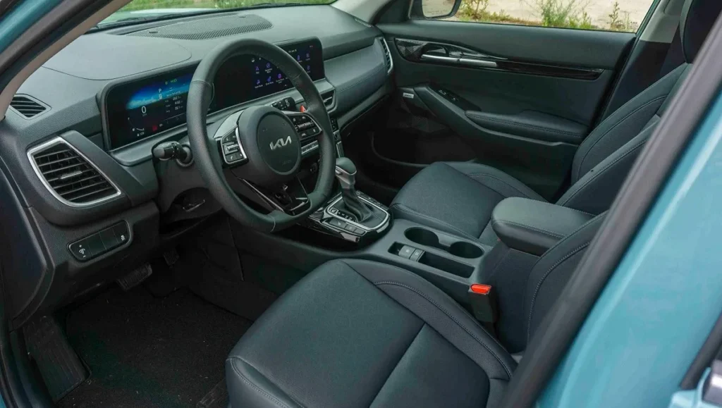 New Kia Seltos variants explained interior cockpit view with seats, steering wheel and touchscreen display