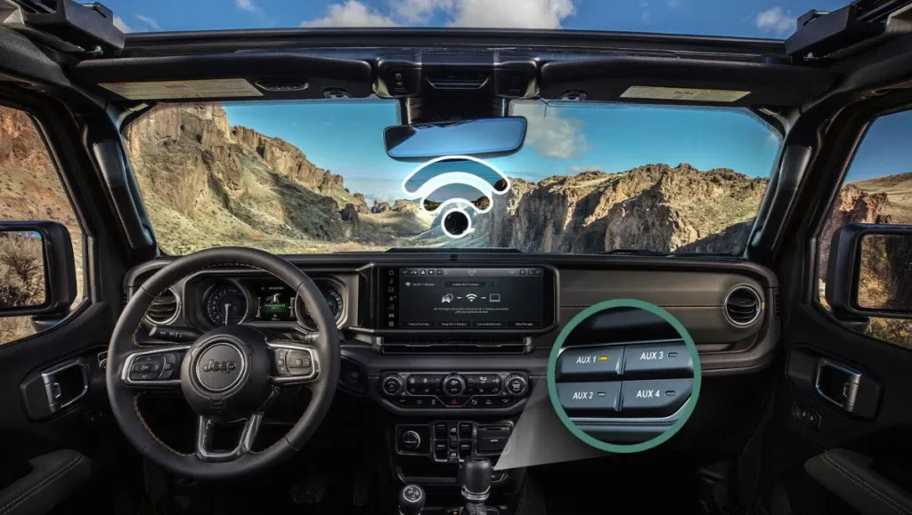 Dashboard view of the 2026 Jeep Wrangler Whitecap featuring infotainment display, steering controls, and auxiliary switches