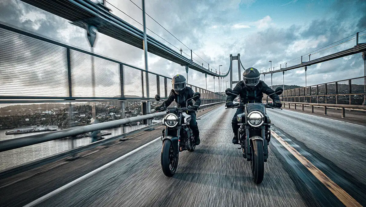 Husqvarna 401 Series Recalled Over Engine Stall Issue shown with riders on Svartpilen and Vitpilen 401 crossing a bridge