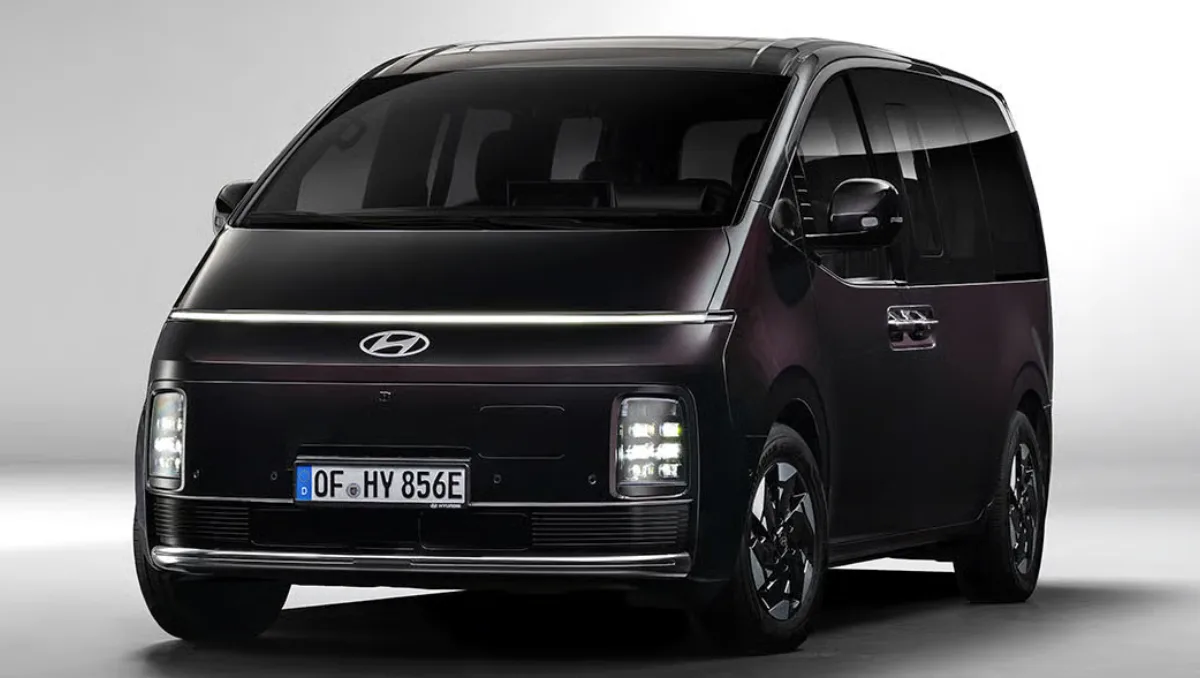 Front-facing studio shot of the new Hyundai Staria Electric highlighting its futuristic LED light bar and 400km range.