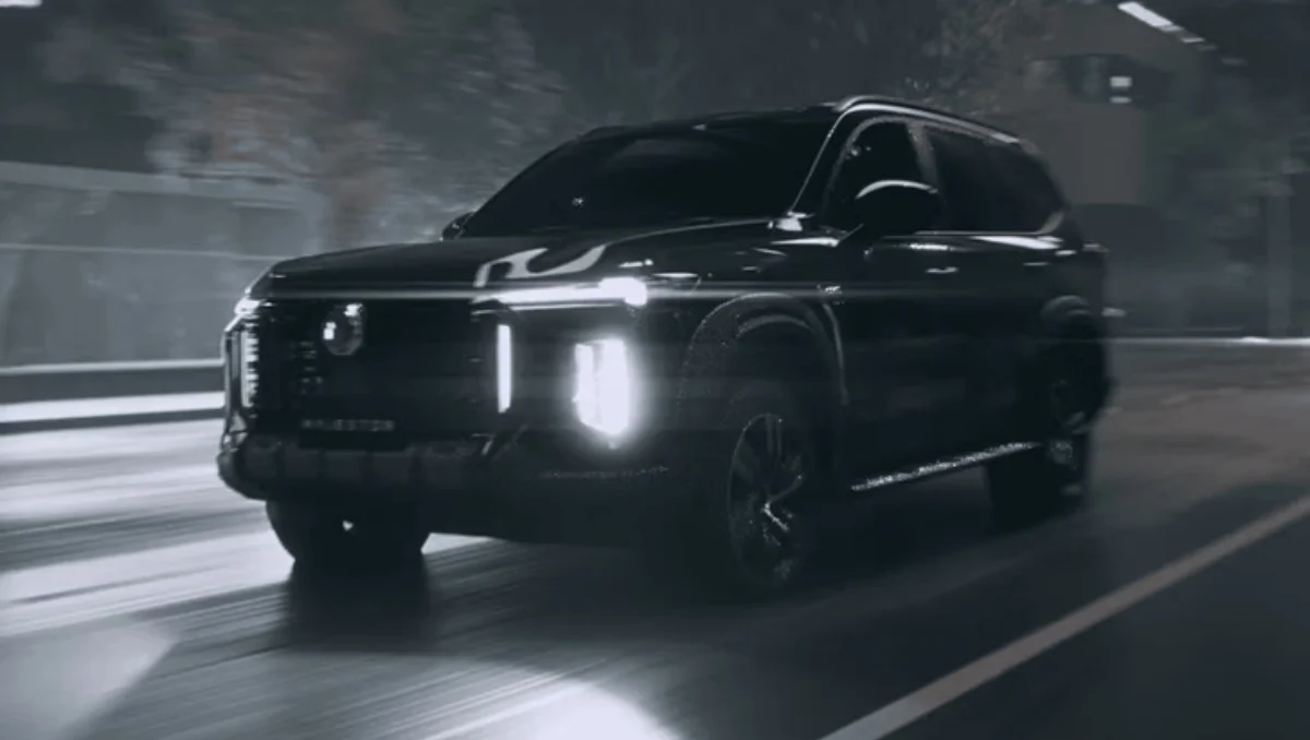 2026 MG Majestor Teased Ahead Of February 12 Launch shown driving at night with illuminated LED headlights and bold SUV stance