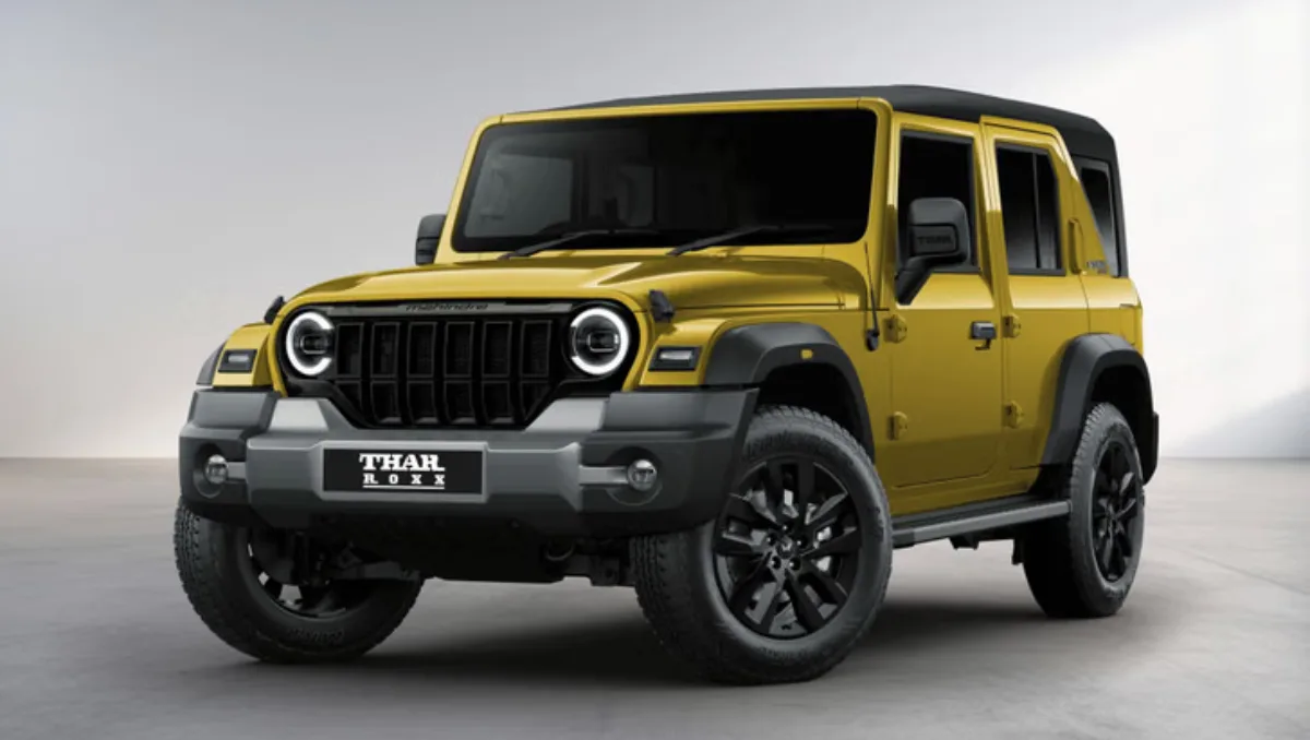 Mahindra Thar Roxx Star Edition Launched showing front three quarter exterior design in gold shade