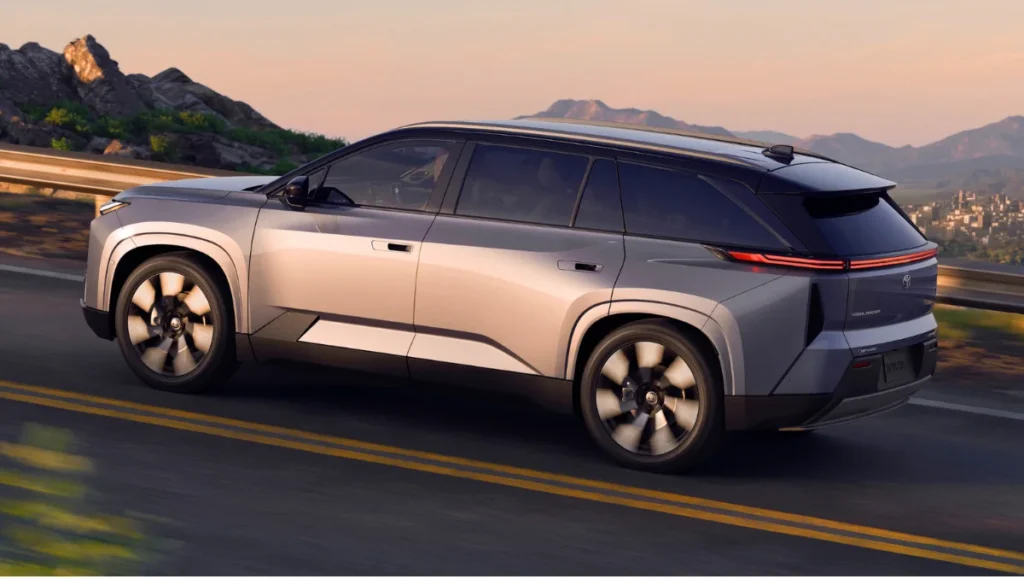 2027 Toyota Highlander EV Debuts showcasing dynamic side profile on open highway