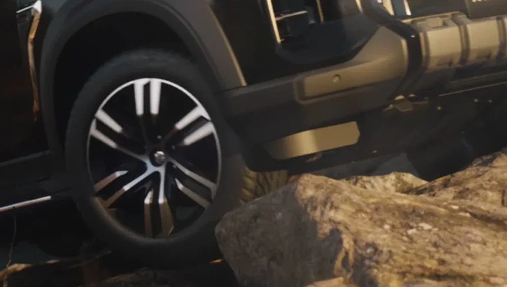 MG Majestor Revealed for India displaying alloy wheels and off-road capability on rocky terrain