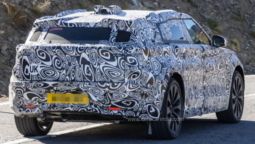 Range Rover Velar EV Spied rear view with camouflaged tail lamps and UK test plate