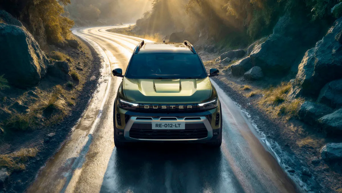 Renault Working On sub 4M SUV Mini Duster driving on a scenic mountain road with bold SUV stance