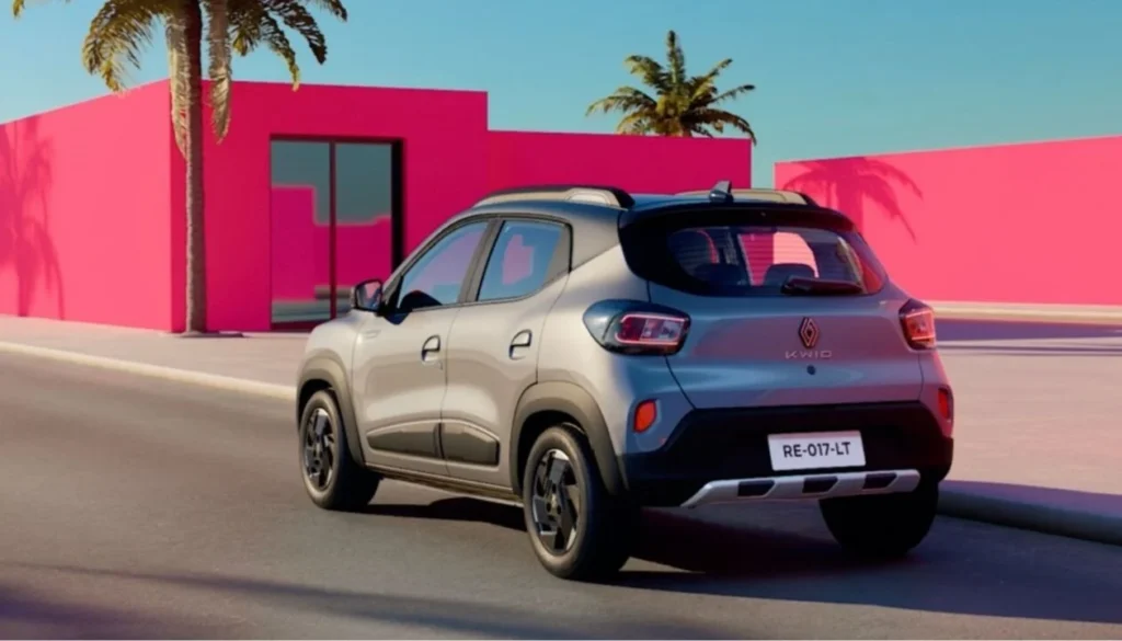 Silver Renault Kwid Facelift debuts rear three-quarter view showing restyled tail lamps, two-tone bumper with skid plate, and roof rails.