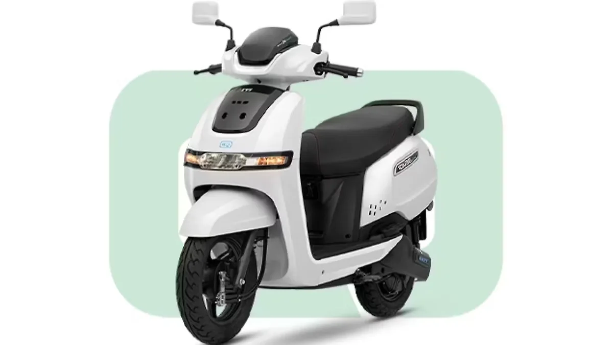 TVS iQube 2.3 kWh Launched at ₹1.16 Lakh showing the front three-quarter view of the electric scooter in Pearl White with LED headlight DRL and black alloy wheels.