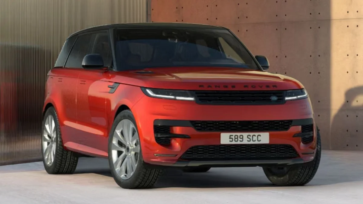 Front three-quarter view of the Range Rover Sport Twenty Edition featuring LED headlights, black grille, and Sanguinello Orange exterior.