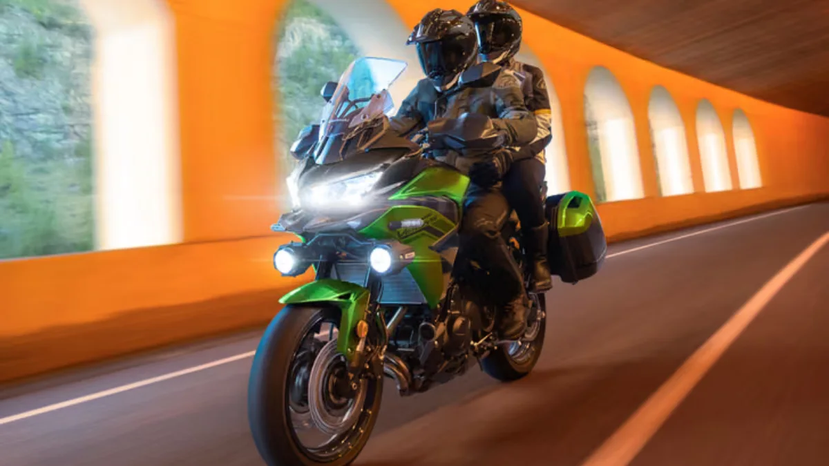 Two riders touring on a highway tunnel road after the official 2027 Kawasaki Versys 650 launch.