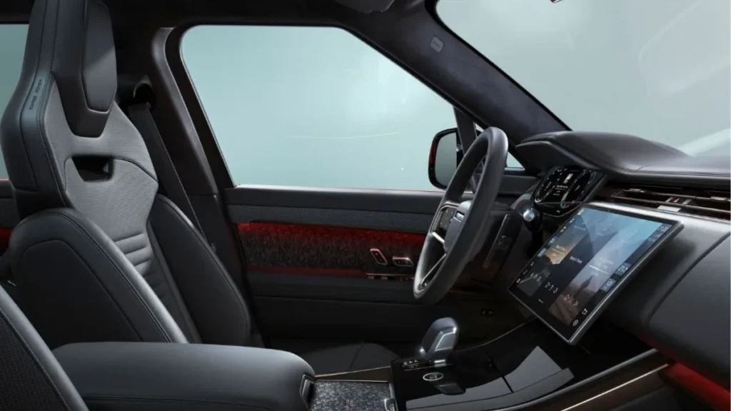 Range Rover Sport Twenty Edition interior cabin featuring Ebony Windsor leather performance seats, forged carbon trim, and Pivi Pro touchscreen infotainment display.