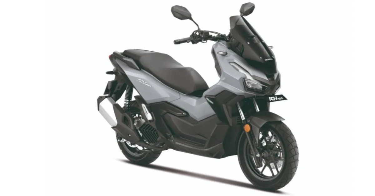 Honda ADV 160 Launched In India Studio shot showing the front three-quarter right side Honda ADV 160 adventure maxi-scooter, featuring matte grey paint and rugged, block-pattern dual-purpose tyres on a white background.
